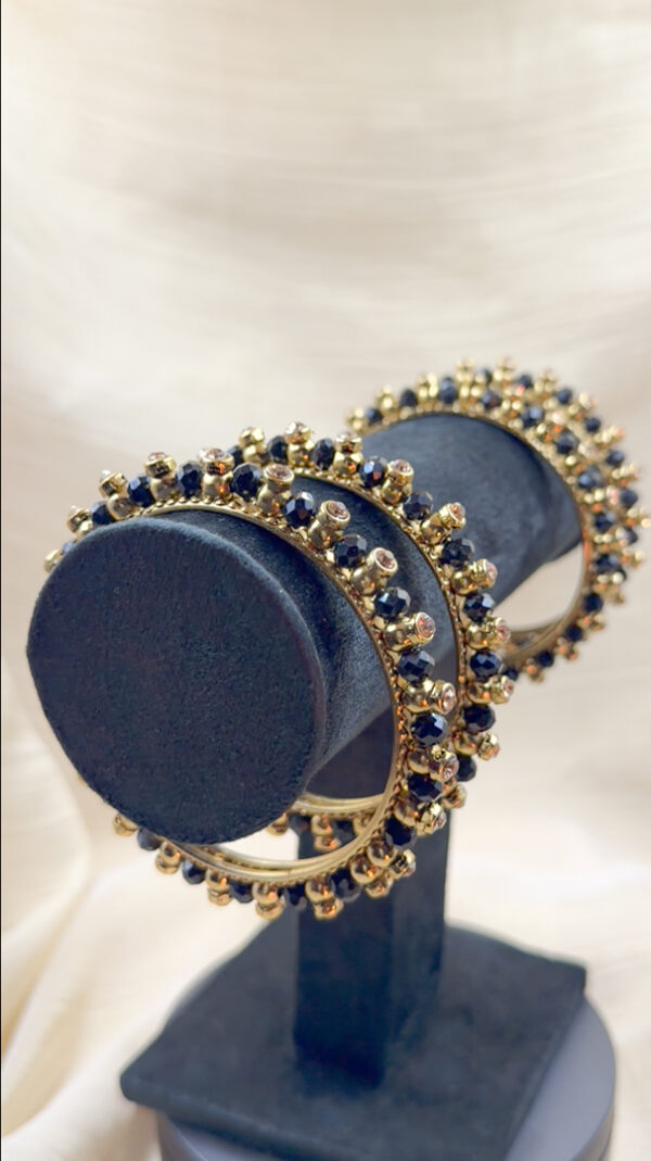 4 black and golden bangles